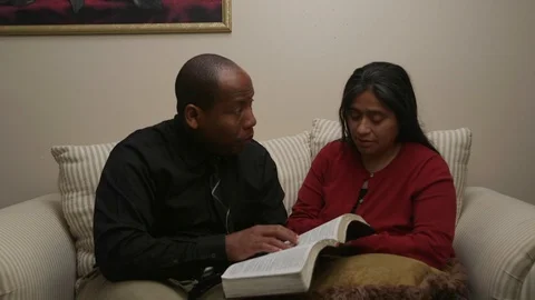 Husband Attempting to Clarify Doubts His Wife Has on the Bible Stock Footage 110908019