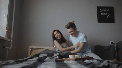 Husband brings coffee to bed Stock Footage 103150191