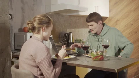 The husband is constantly working on a laptop and talking on a smartphone, not Stock Footage 145083366