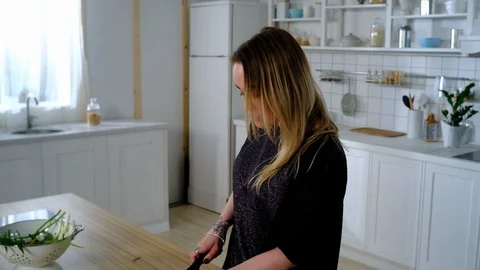 Husband with pineapples came to the kitchen to his wife Video stock 127264336
