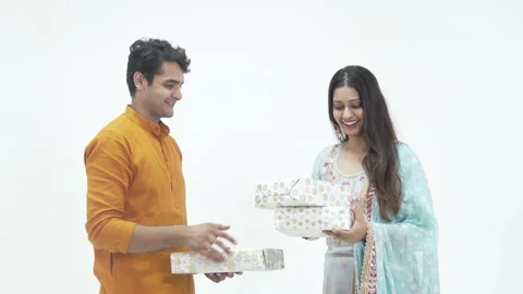 Husband presenting wrapped box to beautiful wife,during diwali Stock-Footage 252584330