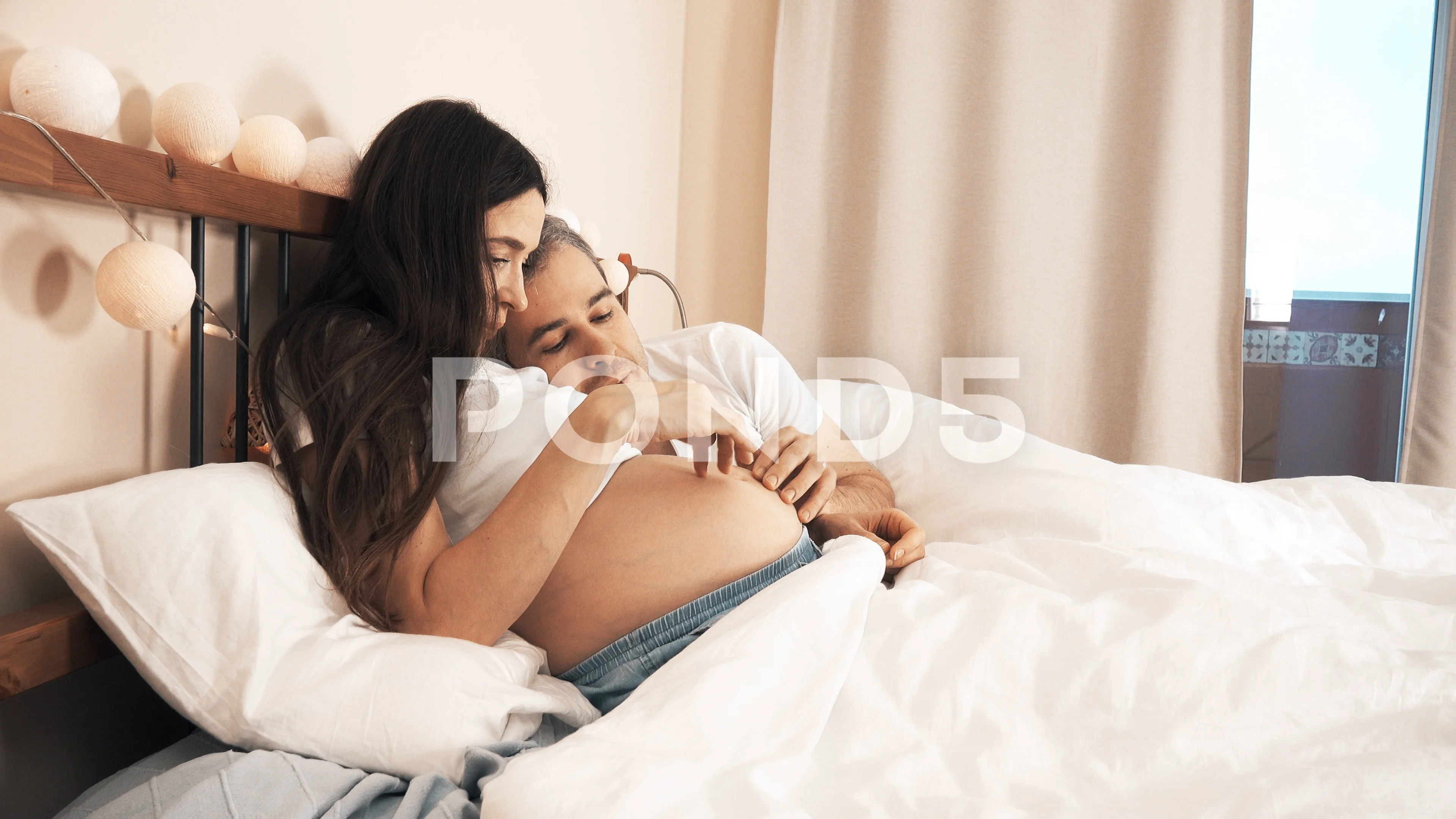 Husband stroking pregnant wifes belly
