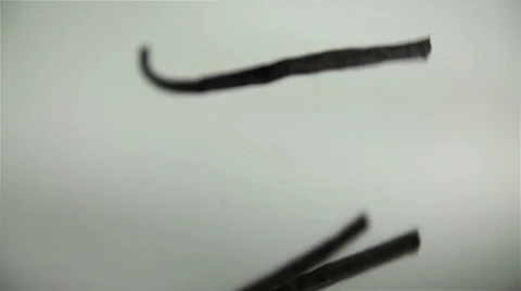 Husk of vanilla falling on mirror in slow motion Video stock 32472084