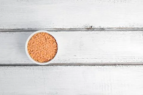 Husked split red lentils in white bowl. 写真素材