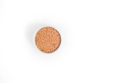 Husked split red lentils in white bowl. Stock Photos
