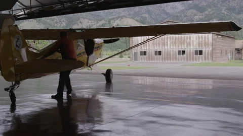 Husky Plane Pilot Rolls out from Hanger - 3840 x 2160 Stock Footage 221412383