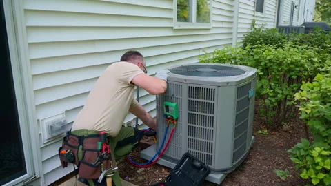 HVAC service worker diagnoses or repairs air conditioner compressor. HVAC Видео 314362729