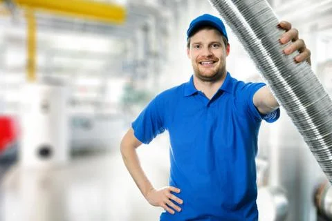 Hvac technician with flexible aluminum ducting tube in hand Stock Photos