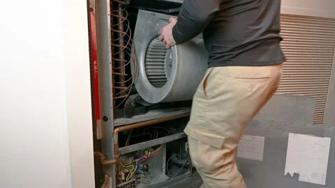 HVAC Technician Installing a Blower Motor Stock Footage 148238919