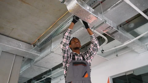 HVAC technician installing ductwork on ceiling Stock Footage 309483866