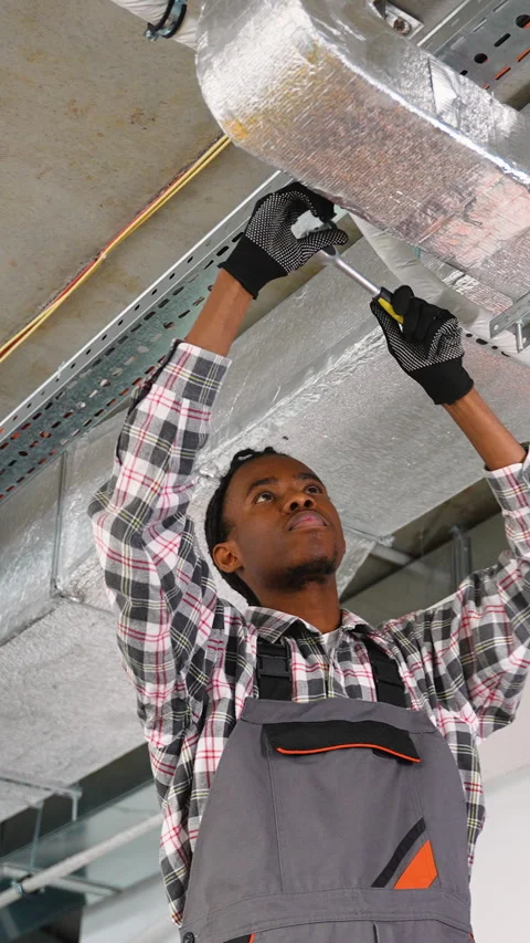 HVAC technician installing ductwork on ceiling Stock Footage 309485972