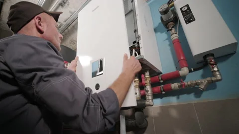 HVAC technician installs heating, ventilation and air conditioning systems Stock Footage 164809586
