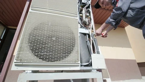 HVAC technician installs heating, ventilation and air conditioning systems Stock Footage 165480746