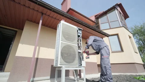 HVAC technician installs heating, ventilation and air conditioning systems Stock Footage 165480971