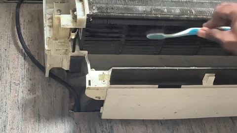 HVAC technician performing split AC filter maintenance and cleaning in indoor Stock Footage 334193710