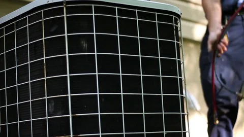 HVAC Technician pulling out cables from old air conditioner unit near home Video stock 75871002