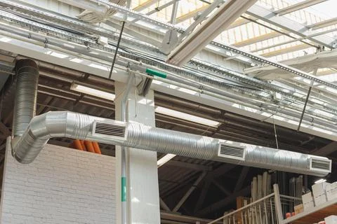 HVAC Ventilation Duct pipe with three grids, hanging under the ceiling inside Stock Photos