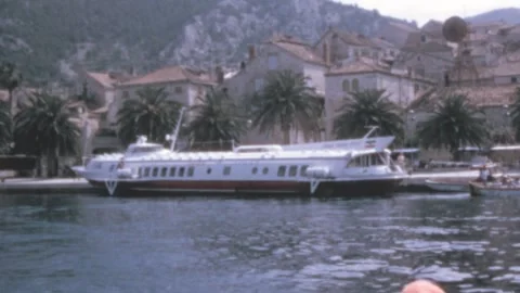 Hvar, Yugoslavia - 1972: Views from the ferry as it leaves island in summertime Stock Footage 241918341
