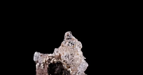 Hyalite opal crystal rotating 360° loop isolated on black background Stock Footage 253100474