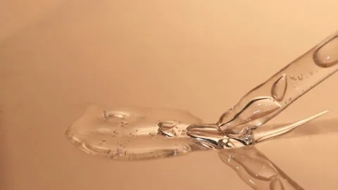 Hyaluronic acid with bubbles on a beige background close-up. Stock Footage 218314008
