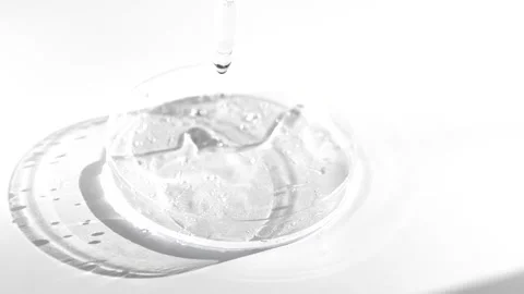 Hyaluronic acid dropping in glass medical petri dish Stock Footage