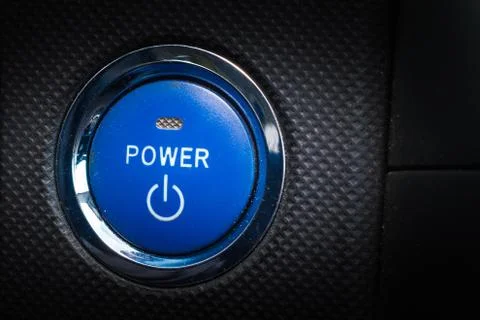 Hybrid car blue start engine button. Stock Photos