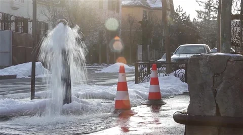Hydrant flowing profusely. at the street corner, in the beautiful winter day Stock Footage 59938682