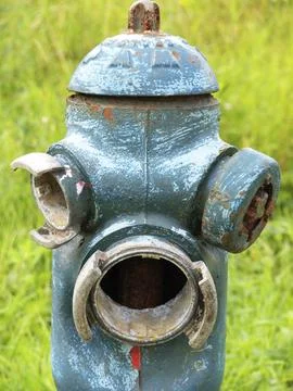 Hydrant painted green, somewhat dilapidated, but nevertheless, or perhaps Stock Photos