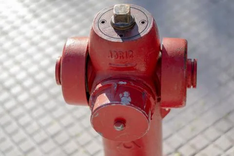 Hydrant on the sidewalk whith the word abrir that means open in spanish. Stock Photos