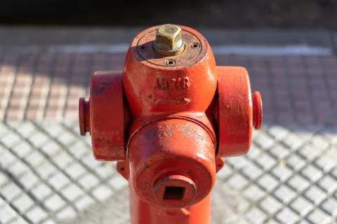 Hydrant on the sidewalk whith the word abrir that means open in spanish. Stock Photos