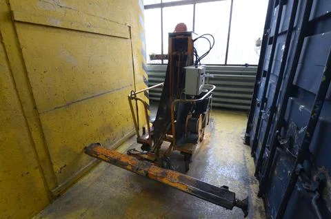 Hydraulic container lifting jack machine inside industrial workshop Stock Photos