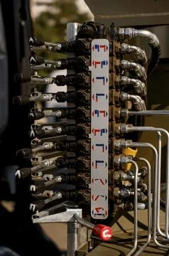 Hydraulic control panel with multiple valves and labeled connections Stock Photos