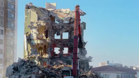 Hydraulic demolition crusher triggering building collapse in Bagcilar Stock Footage 334011915