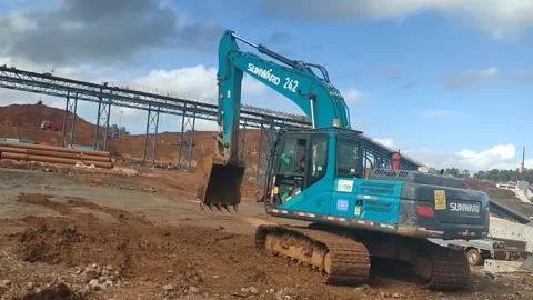 Hydraulic Excavator Performing Earthmoving at Mining Site Viewed from Crane Oper Stock Footage 337153326