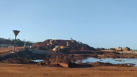 Hydraulic Excavators Loading Dump Trucks at an Open Pit Mining Site Stock Footage 337146536