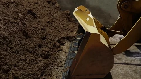 Hydraulic loader bucket digging into raw clay pile inside old Japanese tile Stock Footage 344254327