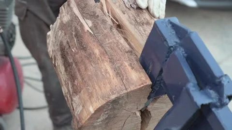 Hydraulic log splitter in action, showcasing precise firewood splitting. Stock Footage 289720516