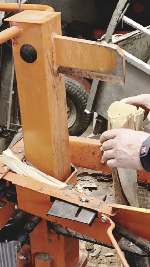 Hydraulic log splitter machine cutting firewood Stock Footage 328156715