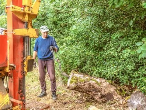 Hydraulic log splitting machine attached to a tractor the machine is being us Stock Photos
