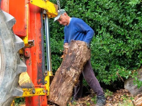 Hydraulic log splitting machine attached to a tractor the machine is being us Stock Photos