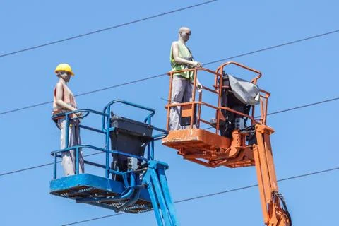 Hydraulic mobile construction platform elevated towards a blue sky with false Stock Photos