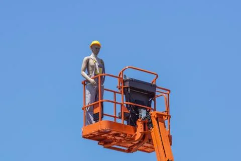 Hydraulic mobile construction platform elevated towards a blue sky with false Foto stock