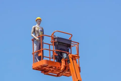 Hydraulic mobile construction platform elevated towards a blue sky with false Foto stock