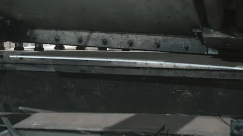 Hydraulic press cuts sheet iron into pieces in a factory Stock Footage 306540744