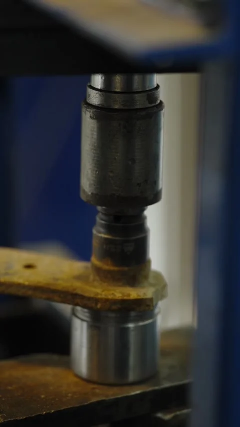 Hydraulic press machine pressing out car bushing from control arm Stock Footage 337568129