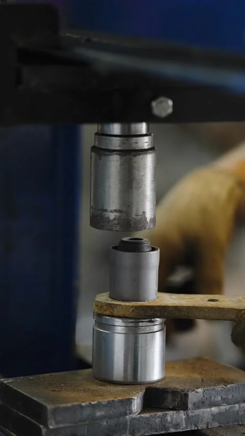 Hydraulic press machine pressing out car bushing from control arm Stock Footage 337568444