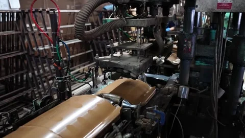 Hydraulic press machine shaping a curved clay roof tile inside a traditional Stock Footage 344247747