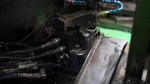 Hydraulic press unit with hoses and metal chute in green factory for pliers Stock Footage 336637357