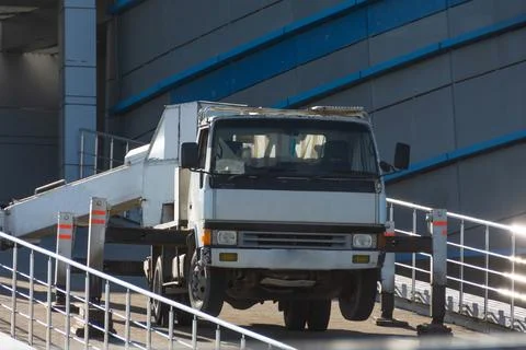 Hydraulics crane support. Small crane truck with outriggers on a sloping road Fotos Stock