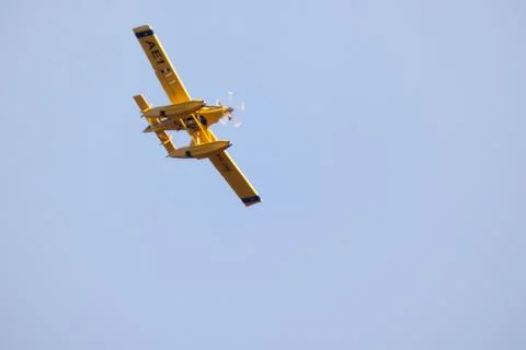 Hydro plane throwing water for fire extinction with deep blue sky on background Stock Photos